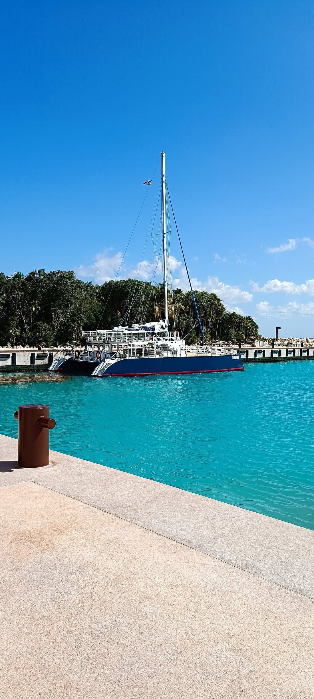 Small sailboats gliding along the coastline at Xcaret